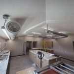 Kitchen dining area with suspended ductwork and exhaust system installation