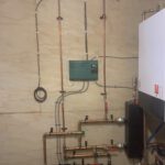 Ceiling-mounted in-floor heating distribution manifold with copper tubes