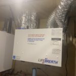 Energy Recovery Ventilator unit with wrapped ducts for fresh air intake