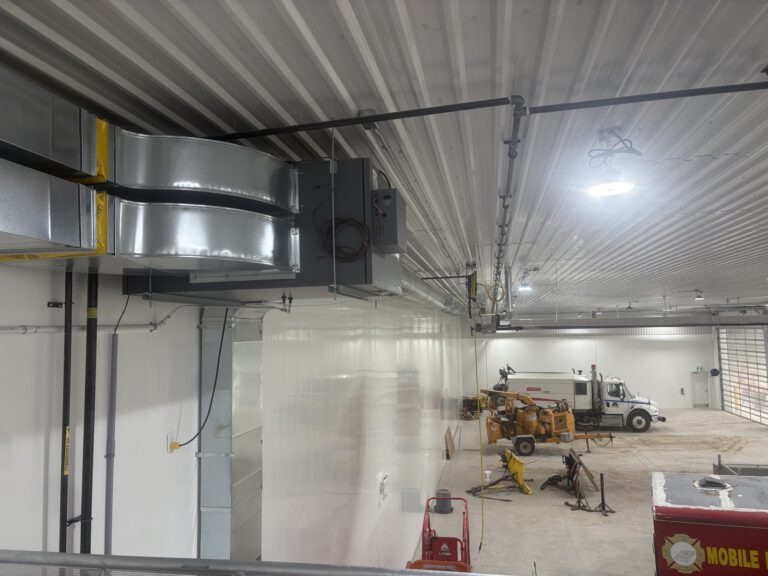 Finished commercial shed interior with equipment and vehicle storage
