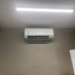 Split-system air conditioning unit installed on interior wall