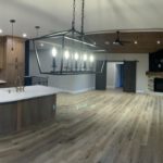 Open-concept kitchen and living space with wood cabinetry, island, and lake views