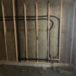 Gas line routed through insulated stud wall