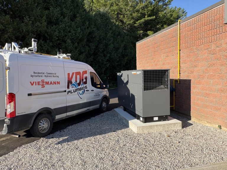 KDG Plumbing van beside installed Generac generator against brick building