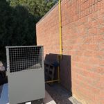 Overhead view of generator installation with metal frame and piping connections