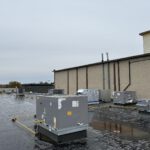 Rooftop commercial HVAC units installed on brick building