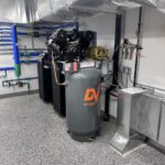 Air compressor with manifold piping and pressure gauge installation detail
