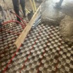 Floor heating junction boxes and supply lines installed in concrete slab