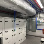 Finished mechanical room with Faldes air handler and blue manifold piping