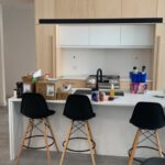 Contemporary kitchen with white island counter and custom cabinetry