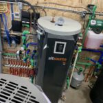 Heat pump manifold with color-coded piping and system instrumentation