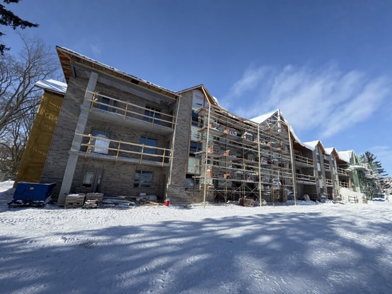 Apartment building exterior in winter with stone and brick facade