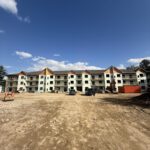 Front-facing apartment complex exterior mid-construction phase