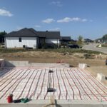 Residential house exterior with radiant heating tubing installed on concrete slab