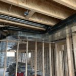 Multi-zone piping system with red and blue tubes organized in framing