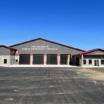 Angled exterior view of main fire hall structure and garage bays
