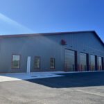 Fire hall exterior showing vehicle entrance bay and office section