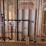 Interior construction showing black PEX in-floor heating and plumbing
