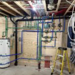 Complete radiant heating installation with water tank, manifold and PEX distribution