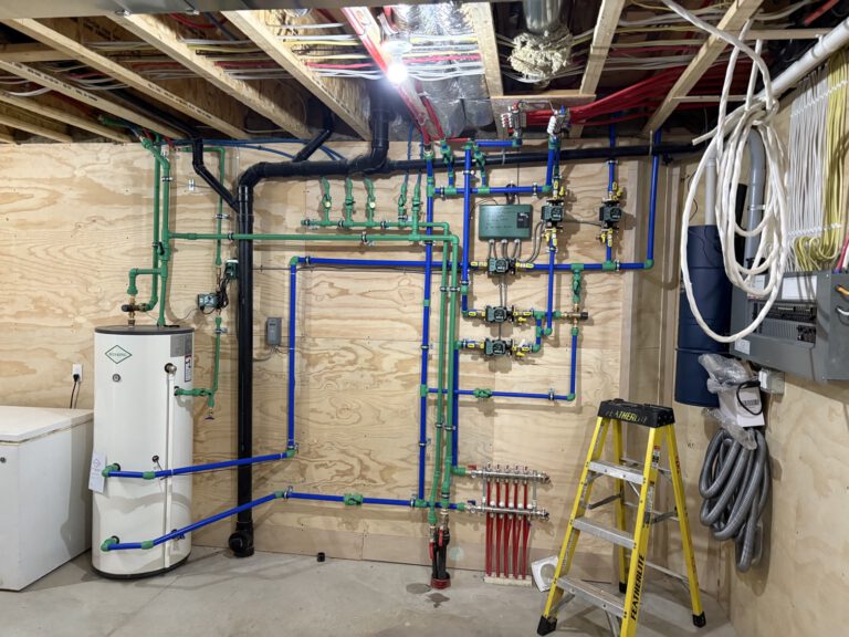 Complete radiant heating installation with water tank, manifold and PEX distribution