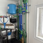 Finished radiant heating system with PEX tubing, tank and smart zone controls