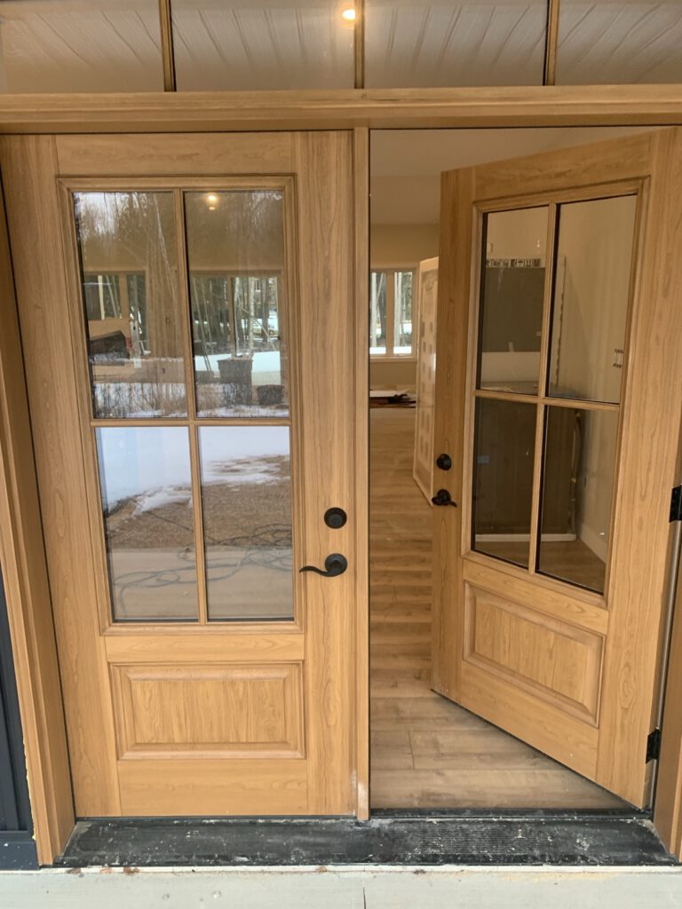 Finished wood cabinetry with glass doors and hardware trim