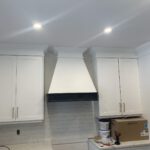 White finished cabinetry installation in bathroom space