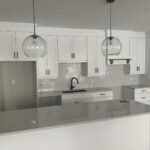 Finished white kitchen with black faucet and island