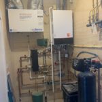 Basement mechanical room with copper plumbing lines, water treatment system