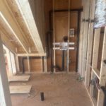 Under-floor wooden joists with installed radiant heating and electrical boxes