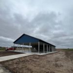Construction phase pavilion with blue roof and white framework