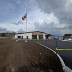 West Grey Paramedic Station exterior with Canadian flag and finished parking area