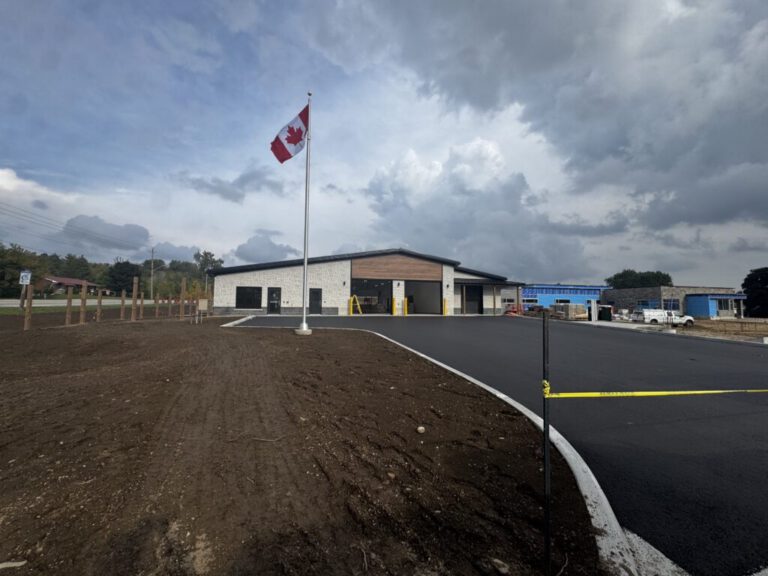 West Grey Paramedic Station exterior with Canadian flag and finished parking area