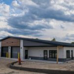 Completed emergency services station building front view with garage bays