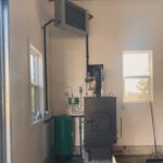 Indoor wood boiler with unit heater in outbuilding