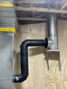 Metal exhaust duct with flexible piping and damper installed in mechanical space