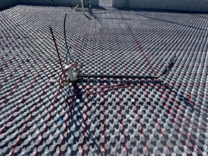 Landscape view of completed radiant heating system with multiple sections and agricultural site context