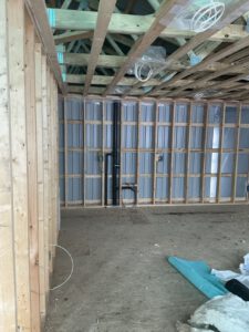 Outdoor radiant heating basin with white concrete walls and complete piping grid system installed