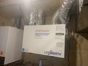Energy Recovery Ventilator unit with wrapped ducts for fresh air intake