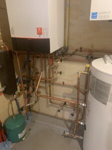 Water heater and boiler assembly with expansion tank and control gauges