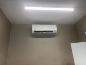 Split-system air conditioning unit installed on interior wall