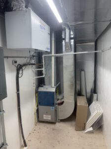 Mechanical utility room with wall-mounted plumbing and HVAC equipment