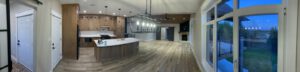 Open-concept kitchen and living space with wood cabinetry, island, and lake views
