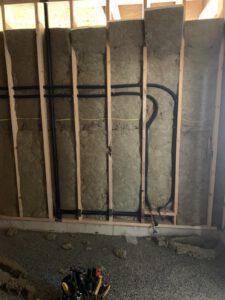 Gas line routed through insulated stud wall