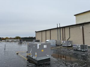 Rooftop commercial HVAC units installed on brick building