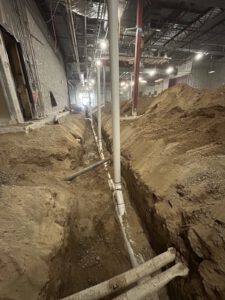 Underground basement piping installation at night
