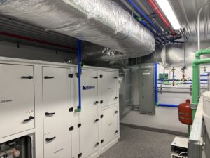 Finished mechanical room with Faldes air handler and blue manifold piping