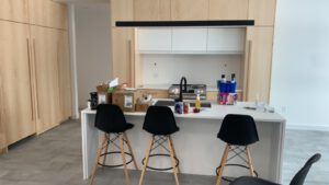 Contemporary kitchen with white island counter and custom cabinetry