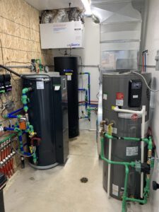 Mechanical room with water heaters, expansion tank, and manifold system