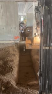 Interior worker installing radiant heating system under floor